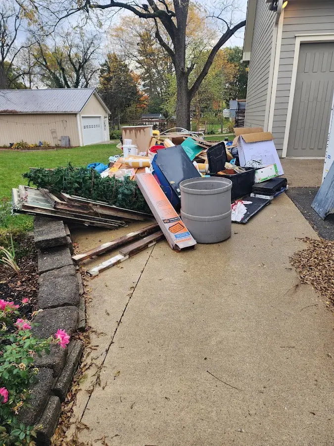 Dumpster being loaded with debris for Commercial Dumpster Rental in Woodson Terrace